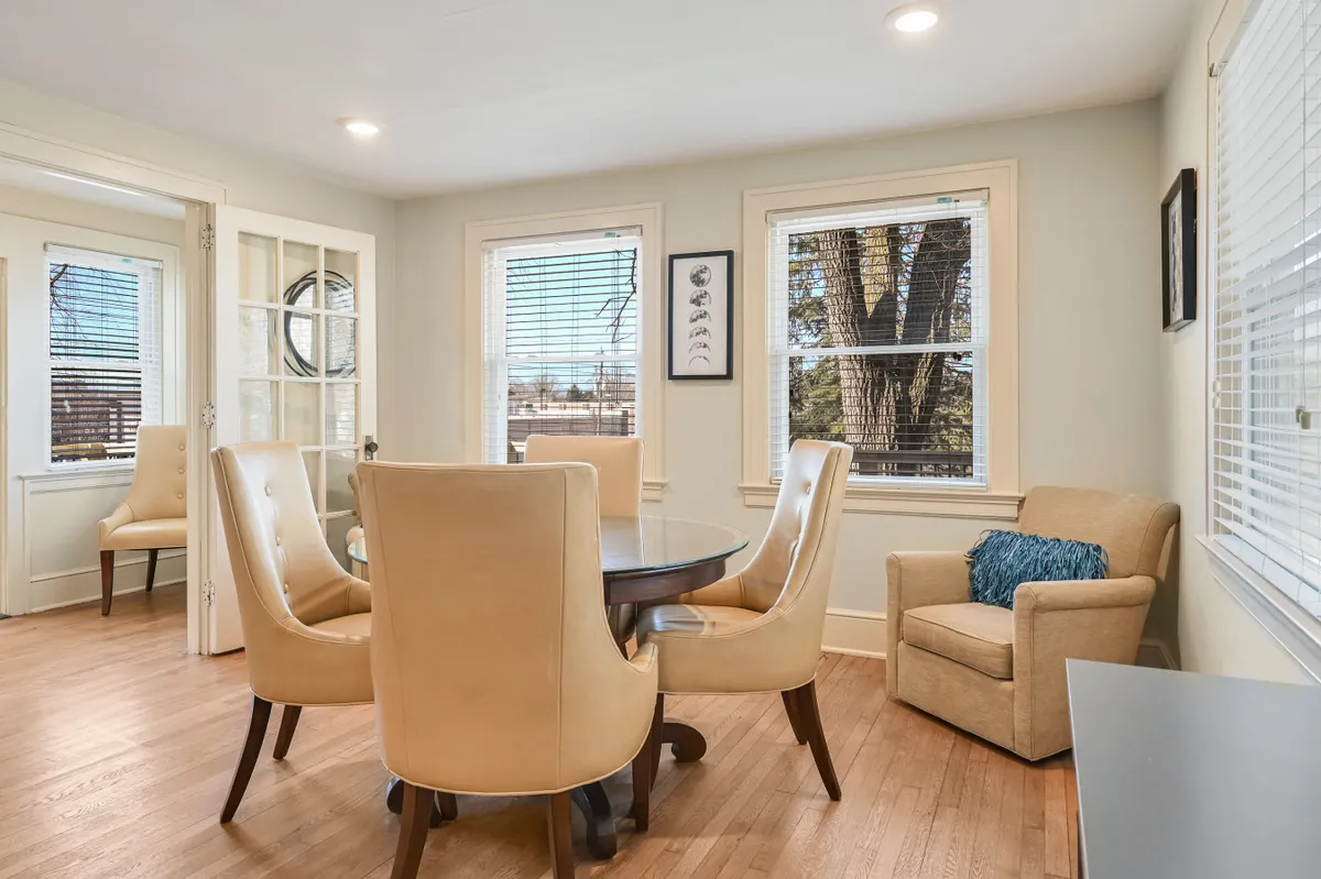 An intimate round dining table surrounded by high-back chairs and an accent chair, set in a welcoming and comfortable atmosphere. The space is suited for family meals, intimate gatherings, and casual conversations, with a layout that encourages both group collaboration and smaller breakout discussions.